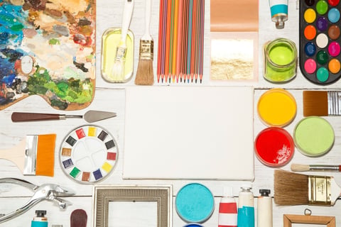 Various painting equipment on wooden background