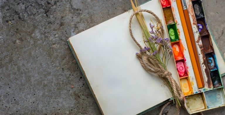 Rustic vintage notebook with watercolor paints